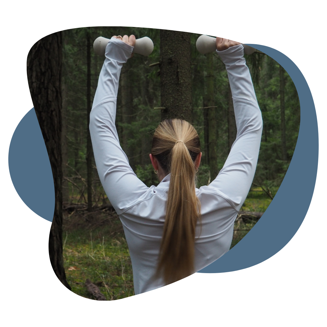 person performing a shoulder press in the forest