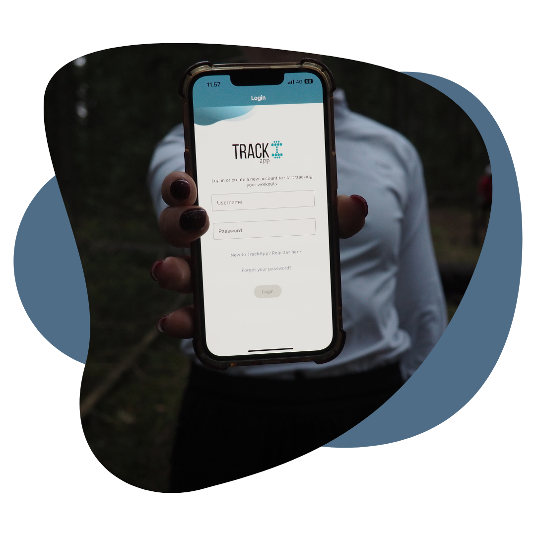 person holding iPhone with TrackApp workout tracking application displayed